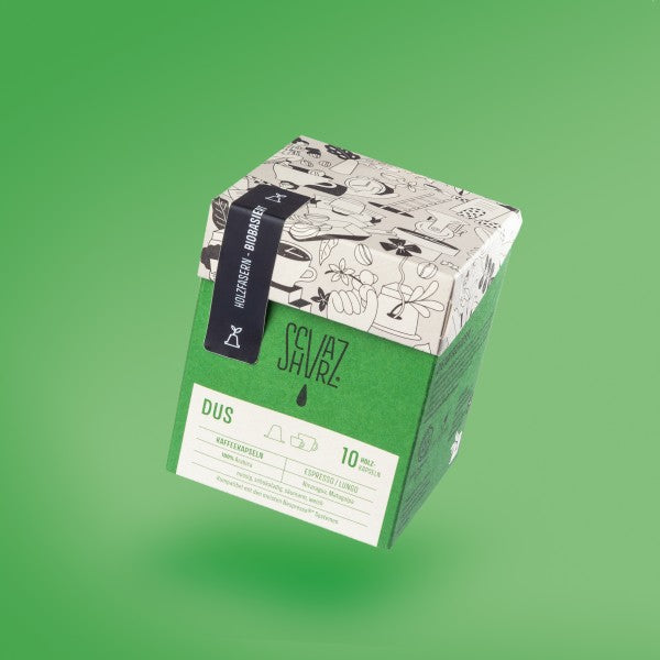Produktbild Kapselbox der Sorte DUS vor grünem Hintergrund.